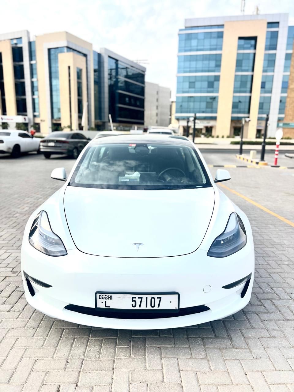 Tesla Model 3 — rear three-quarter view